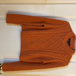 This is a Tommy Hilfiger sweater orange/coral color size small
